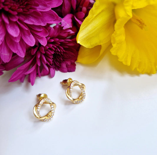 close up of gold knot studs