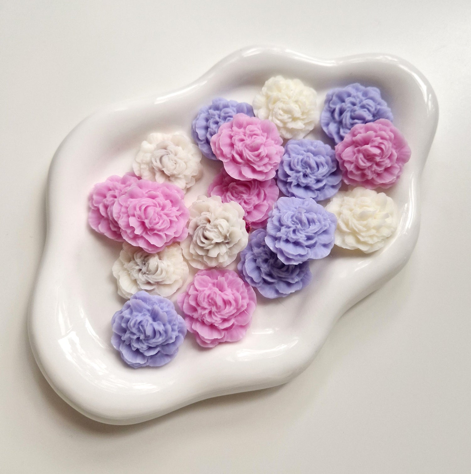 lots of peony shaped wax melts all different colours