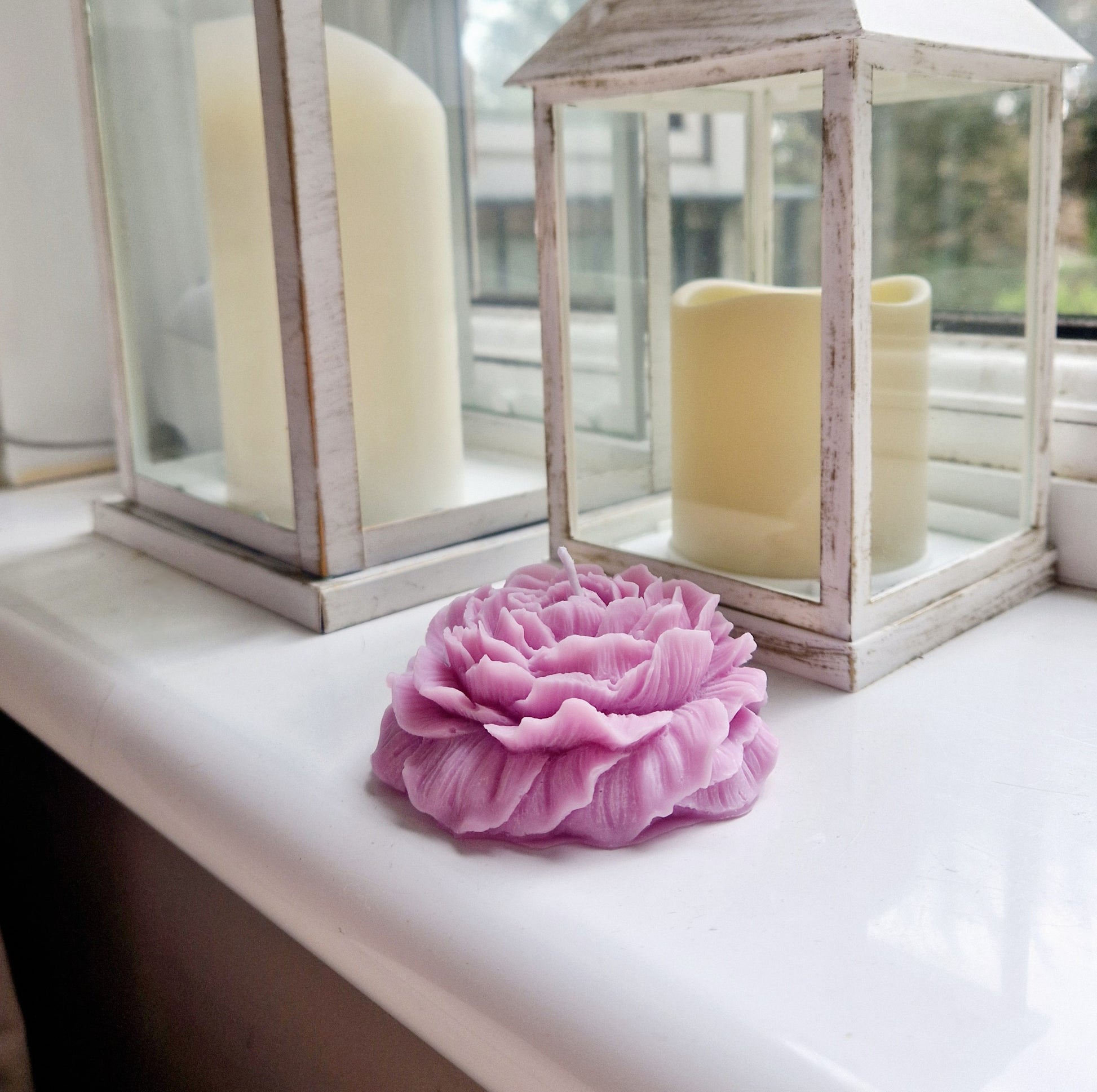 pink peony candle on window sill