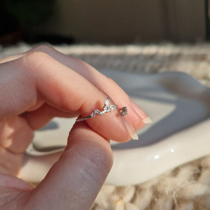 hand holding a dainty silver butterfly ring
